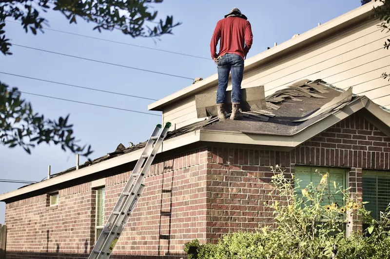 Professional roofer working on a residential roof in Wolfe Park
